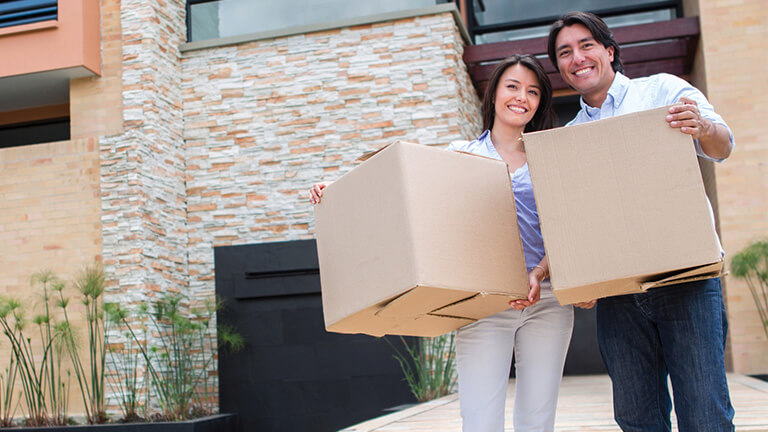 Happy couple moving into home